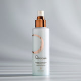 Osmosis Mineral Hydration Finishing Mist bottle on a gray background