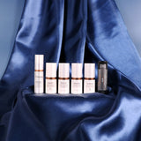 Skincare product lineup on a blue satin background