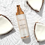 Omniasis Deep Clean detox cleanser bottle with coconut halves on a textured white background