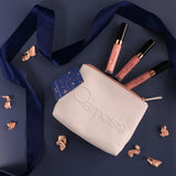 Osmosis makeup bag with lip products on a dark blue background