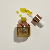 Osmosis Nourish Avocado Facial Oil with dropper on a beige background