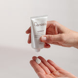 Osmosis Quench skincare product being applied to a hand on a light background