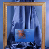 Blue box with sun design on a blue fabric background