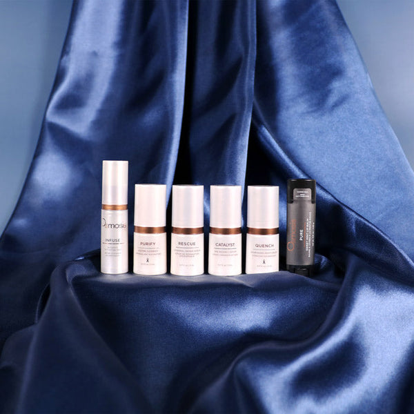 Skincare product lineup on a blue satin background