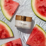 Osmosis Watermelon mask surrounded by watermelon slices on a white background