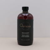 Bottle of Osmosis Recovery supplement on a light gray background