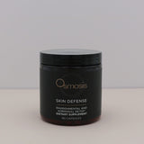 Black container of Osmosis Skin Defense dietary supplement on a light gray background